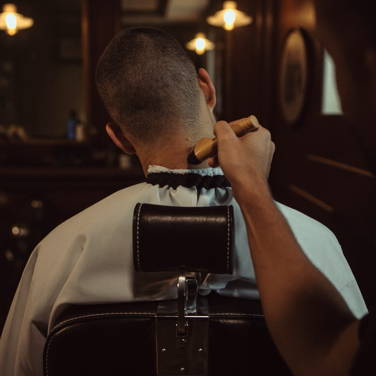 Barber brushing off a client's neckline