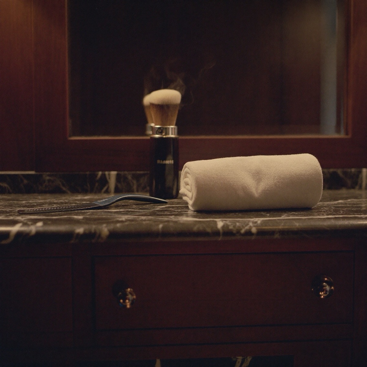 Straight razor and hot towel on the counter